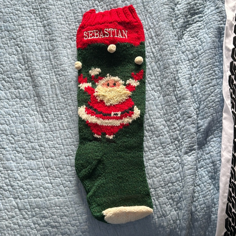 Hand knit Christmas stocking embroidered with name Sebastian
